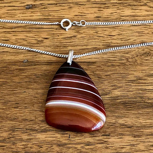Vintage 925 Silver Polished Red Banded Agate Pendant and Chain with Wooden Background