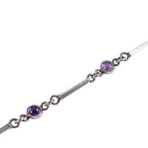 Close up of Dainty Cabochon Amethyst Silver Bracelet with Silver Shell Charm