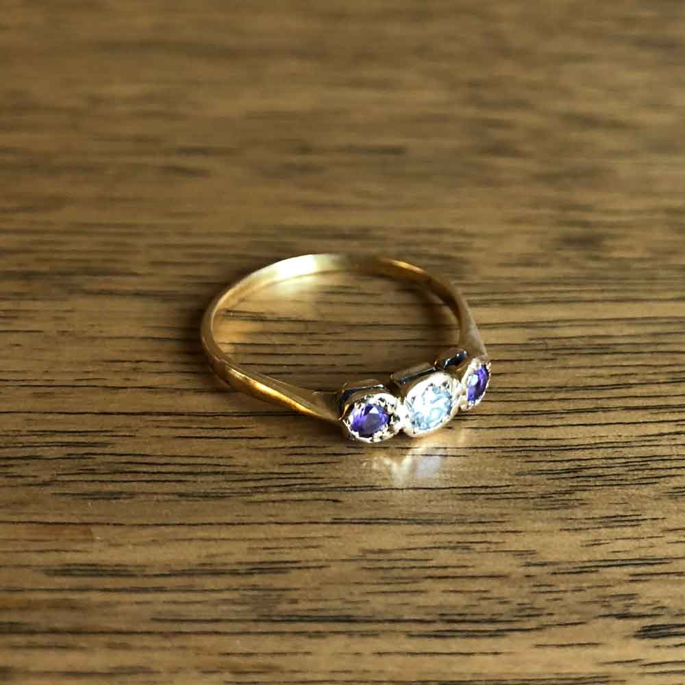 Vintage Amethyst and Diamond Three Stone Ring with Wood Background