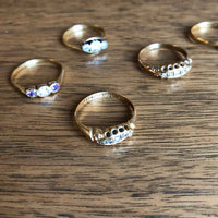 Selection of Rings including of Edwardian 18ct Yellow Gold 5 Stone Diamond Ring with Wood Background