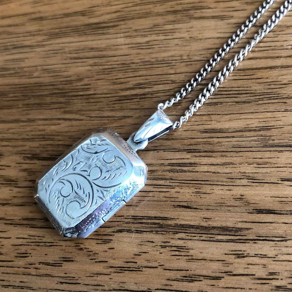 Vintage Etched Sterling Silver Locket -Lying flat on wood table