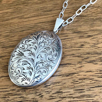 Vintage Engraved Silver Oval Locket - Wood Background