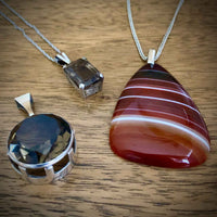 A selection of pendants including a Vintage Smokey Quartz Silver Pendant 