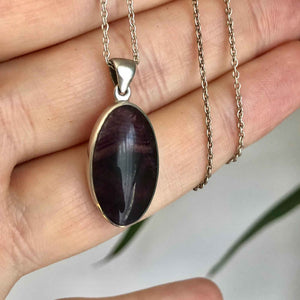 Vintage Blue John Oval Silver Pendant in the Hand indoors