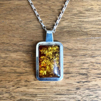 Modernist Vintage Imported Silver Amber Pendant and Chain on Wooden Background