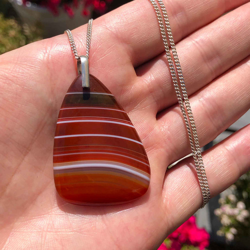 Vintage 925 Silver Polished Red Banded Agate Pendant and Chain outdoors in the hand