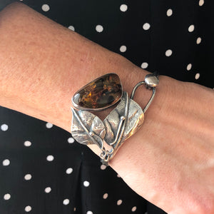 Polish Sterling Silver Baltic Honey Amber Bangle on the wrist - Jewellery Hound
