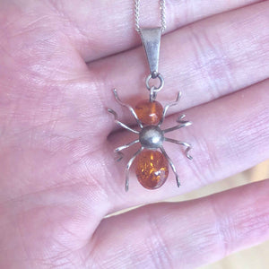 Vintage Silver and Amber Spider Pendant and Chain in a Hand
