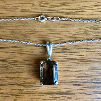 Vintage Smokey Quartz Silver Pendant lying on a wooden table