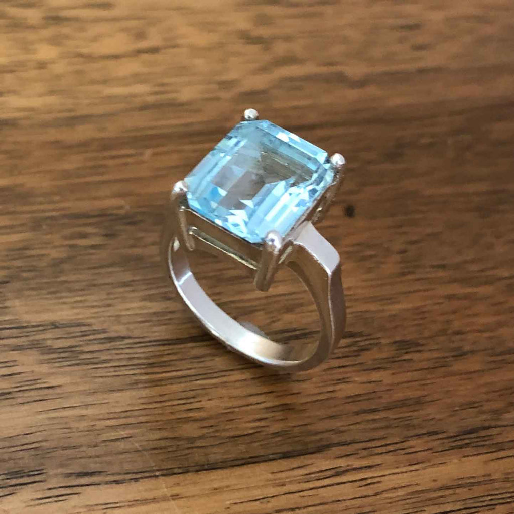Vintage Silver Large Synthetic Emerald Cut Aquamarine Solitaire Statement Ring Standing Alone on Wooden Table
