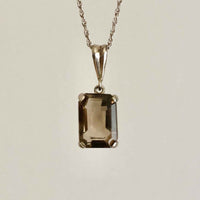 Vintage Smokey Quartz Silver Pendant Hanging with a grey background