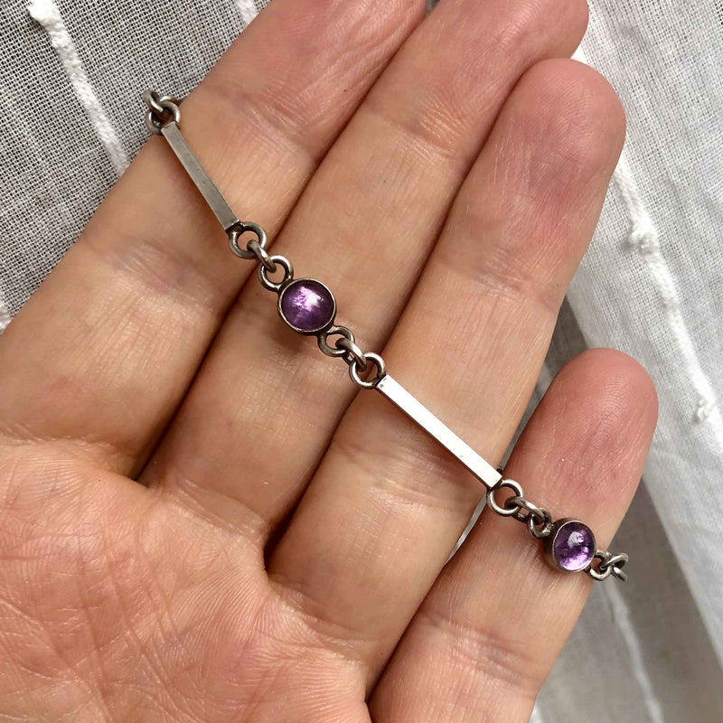 Dainty Cabochon Amethyst Silver Bracelet with Silver Shell Charm in Hand