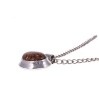 Minimalist Vintage Sterling Silver Amber Pendant lying Flat on White Background