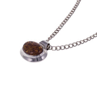 Minimalist Vintage Sterling Silver Amber Pendant at an angle lying flat