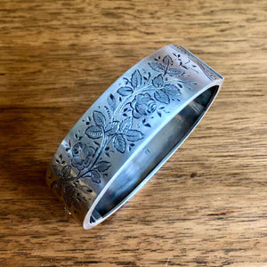 Victorian Sterling Silver Hinged Bangle with Floral  Engraving on Wooden Table