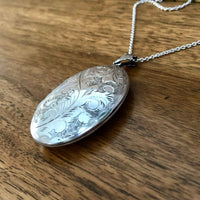 Large Vintage Engraved Silver Oval Locket - With a 22” Long Silver Chain lying flat