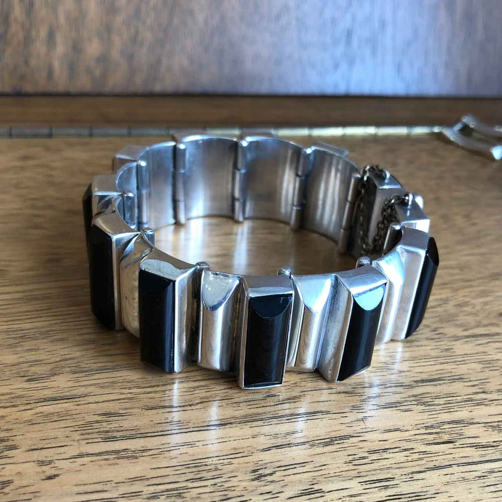 Heavy Vintage Mexican Silver and Onyx Bracelet on Wooden Background