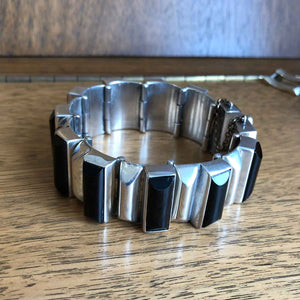 Heavy Vintage Mexican Silver and Onyx Bracelet on Wooden Background